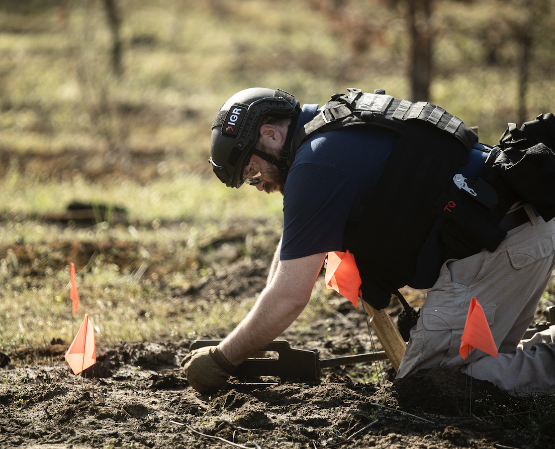 An IGR team member working inside a marked clearance area