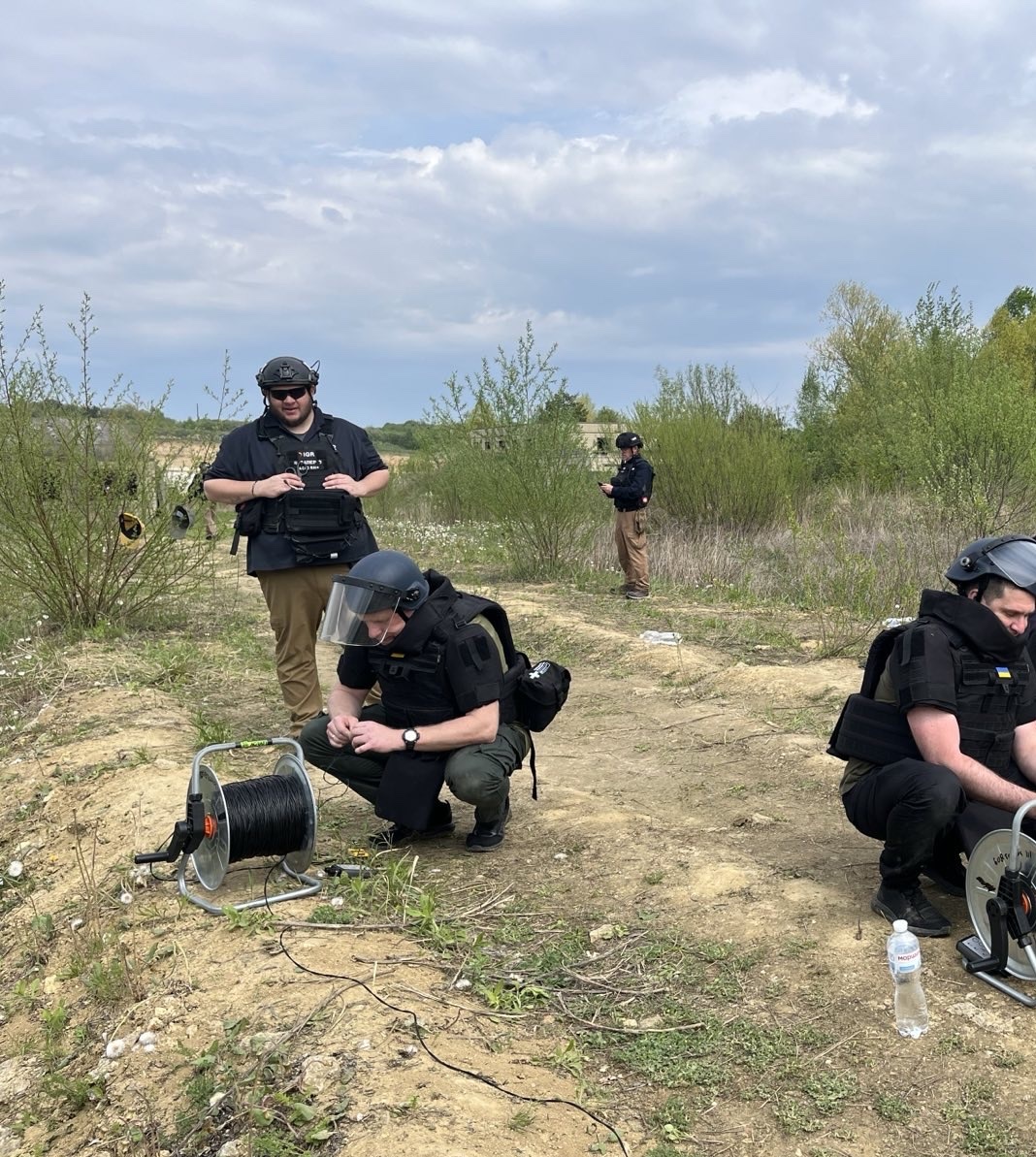 An IGR mentor conducting practical training with Ukrainian deminers in Lviv
