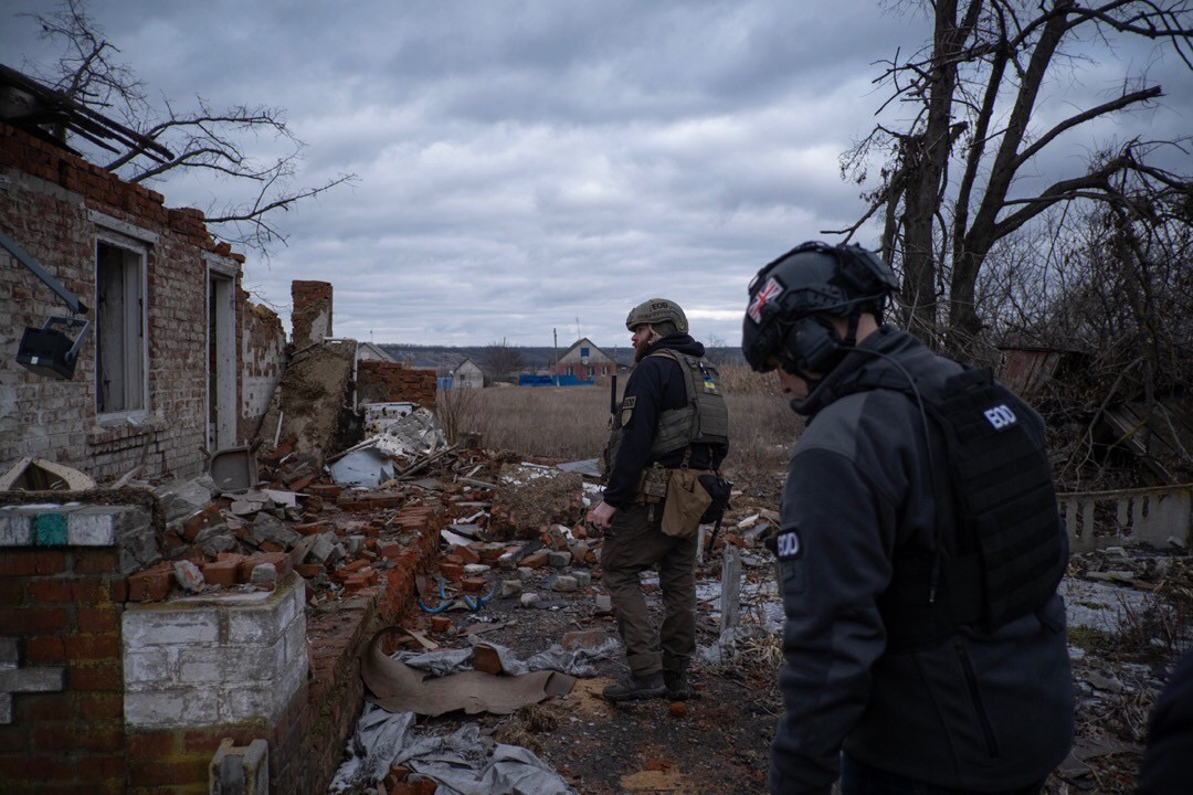 IGR personnel assessing conflict damage in a residential community