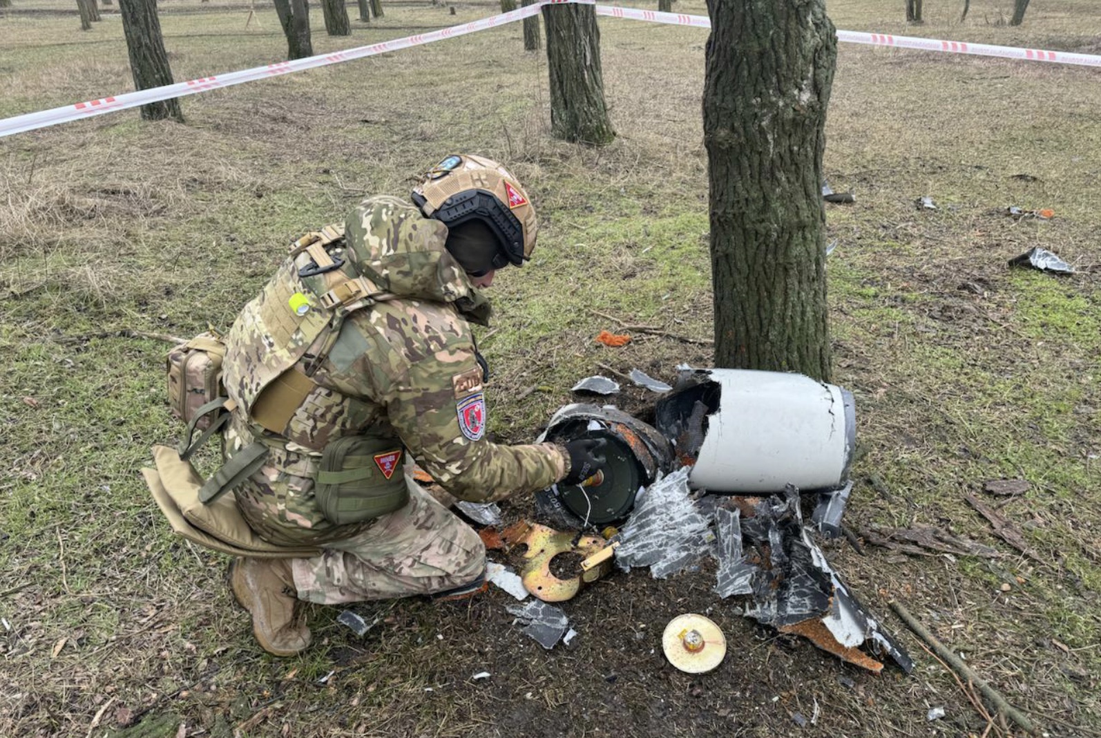 National Police of Ukraine personnel examining drone wreckage