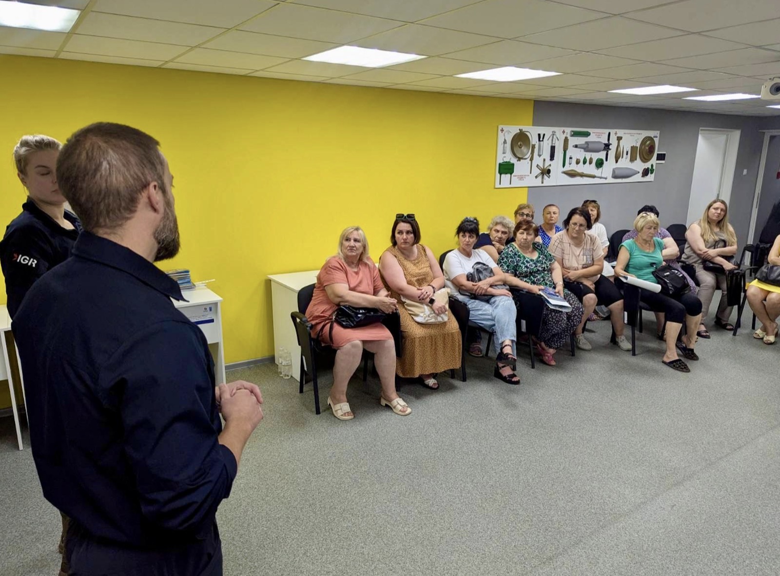 IGR personnel delivering explosive ordnance risk education to community members