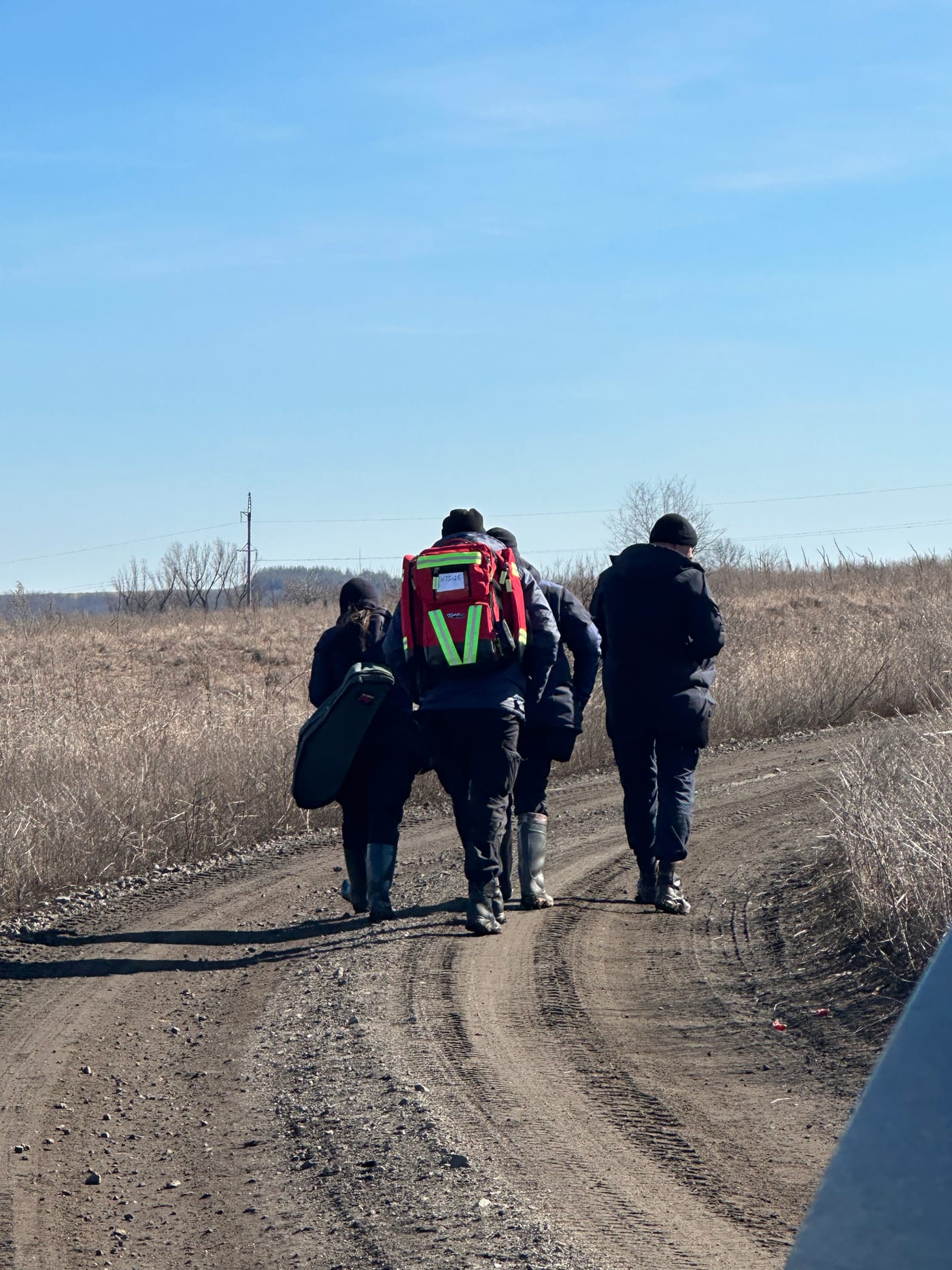 An IGR field team walking a rural route during a survey and assessment