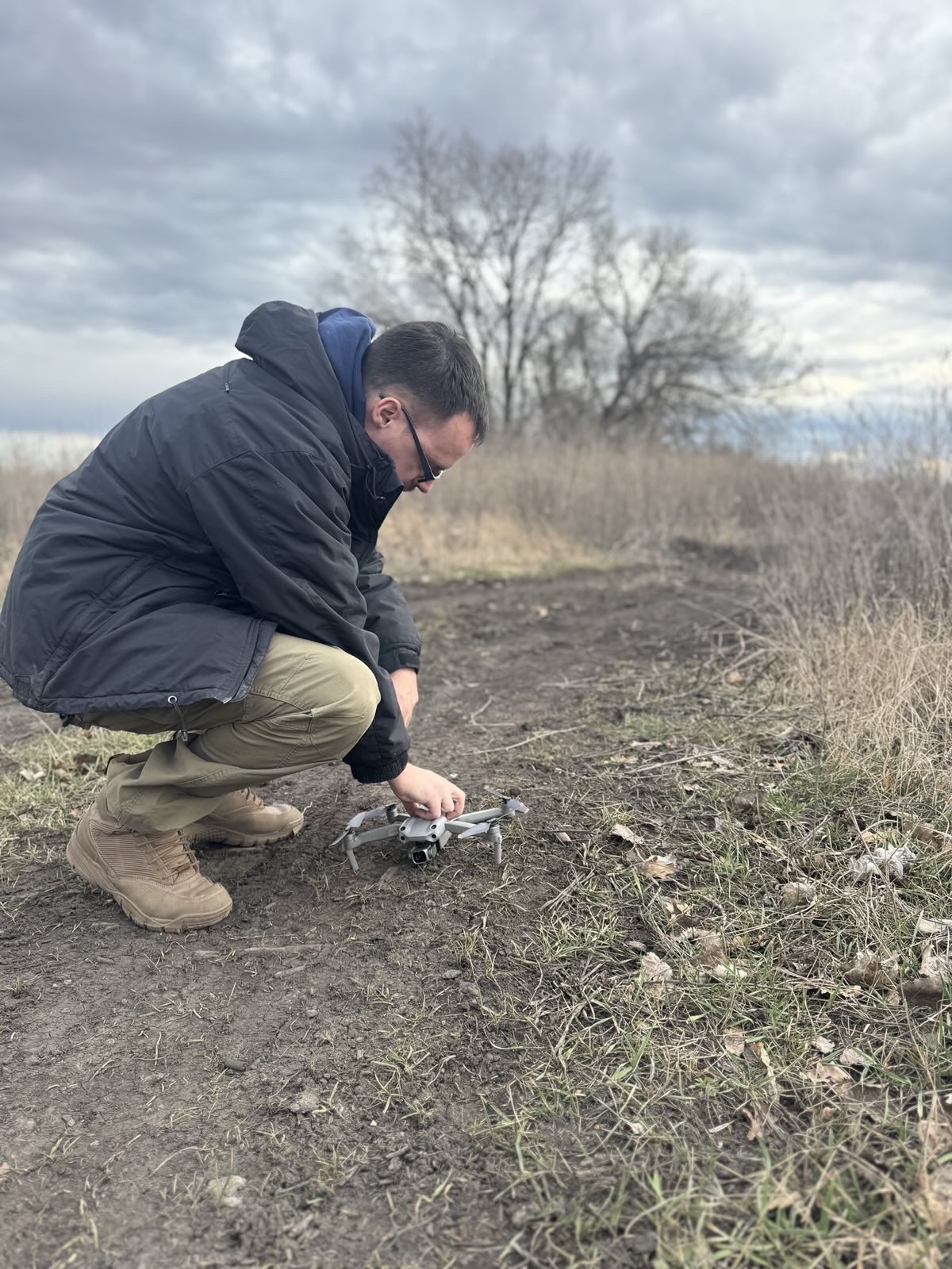 An IGR team member preparing a drone for field survey work in Ukraine