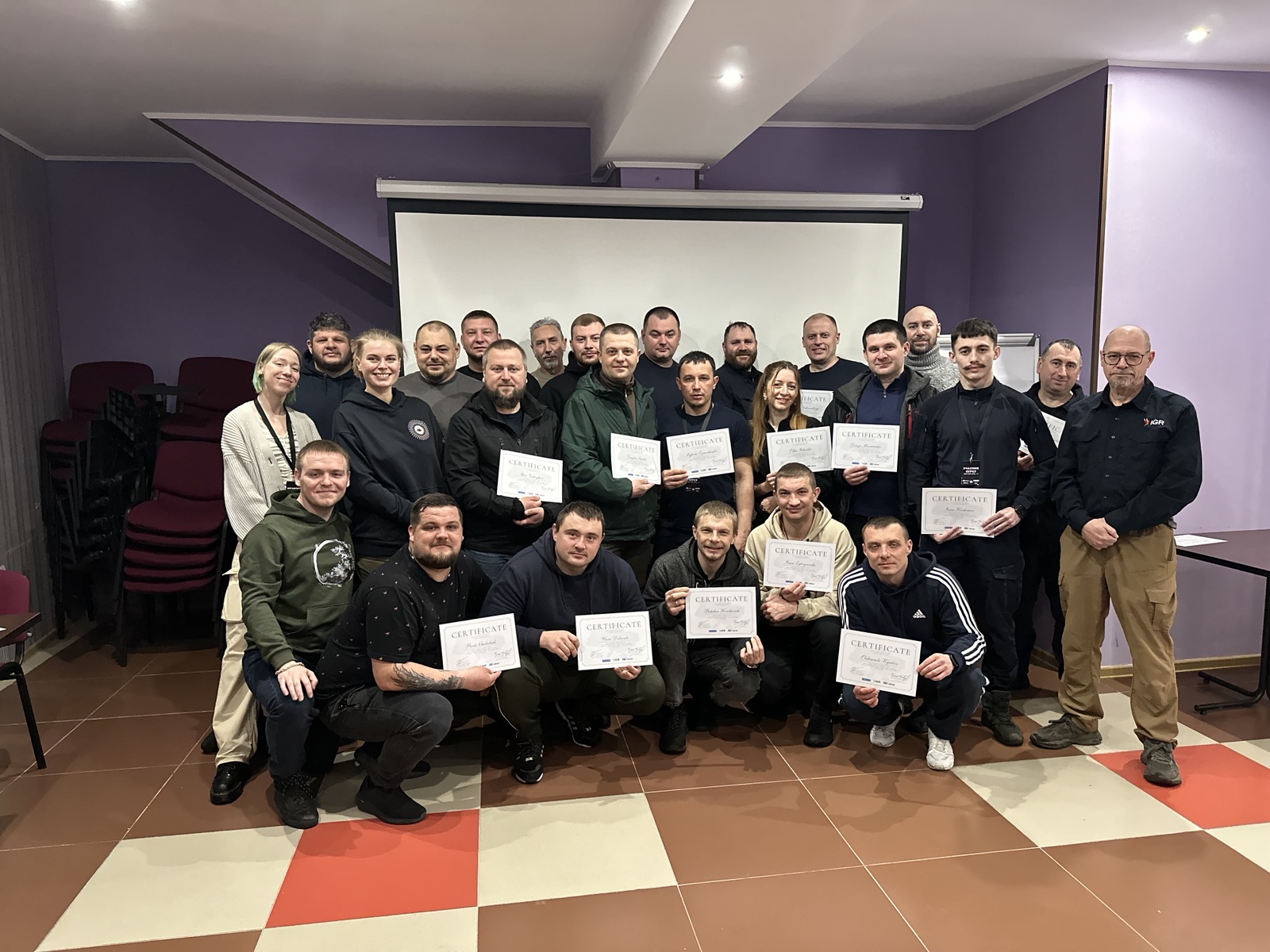 Ukrainian students and instructors holding certificates after completing training