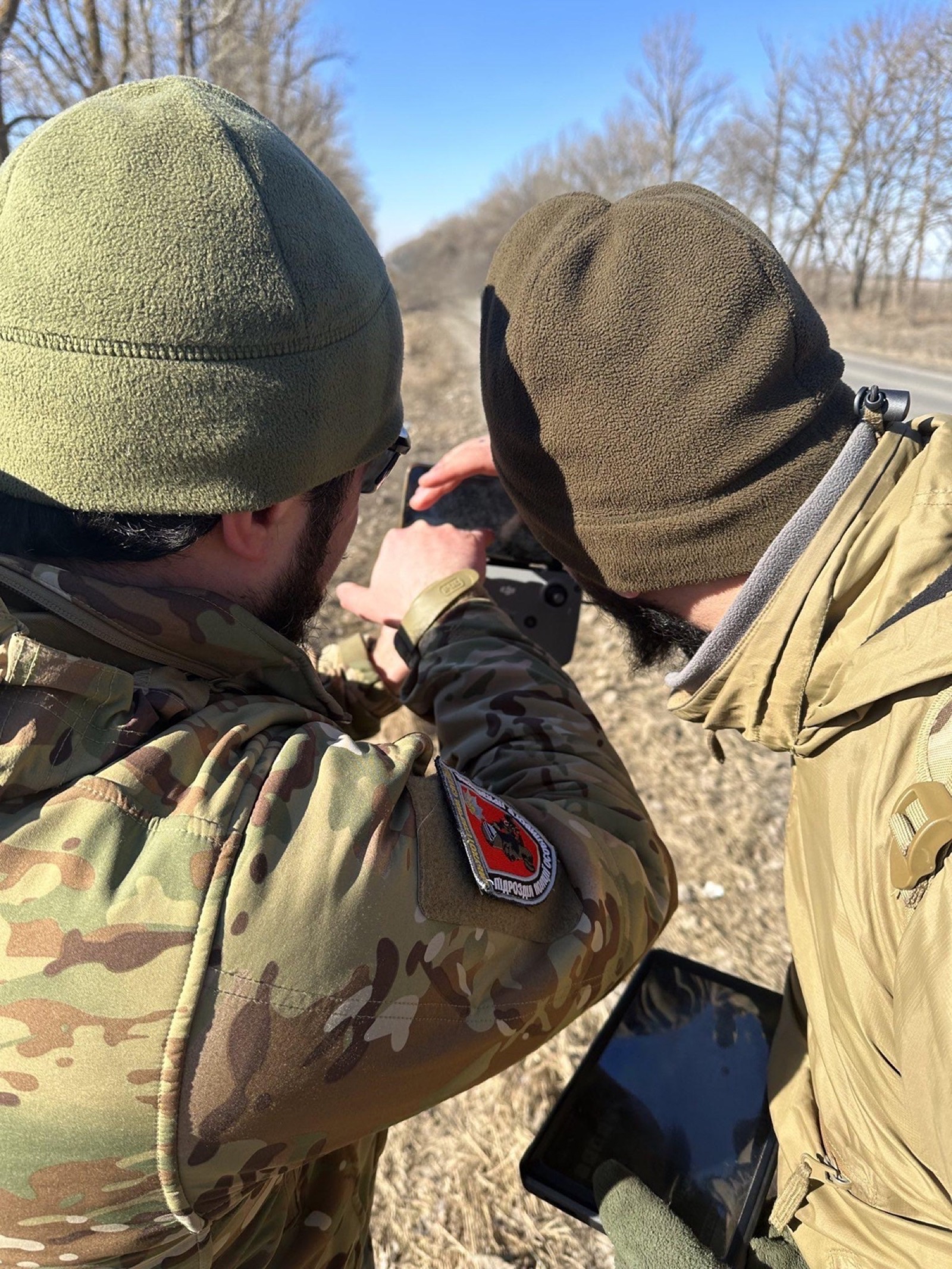 An IGR advisor and Ukrainian counterpart reviewing drone imagery during a field assessment