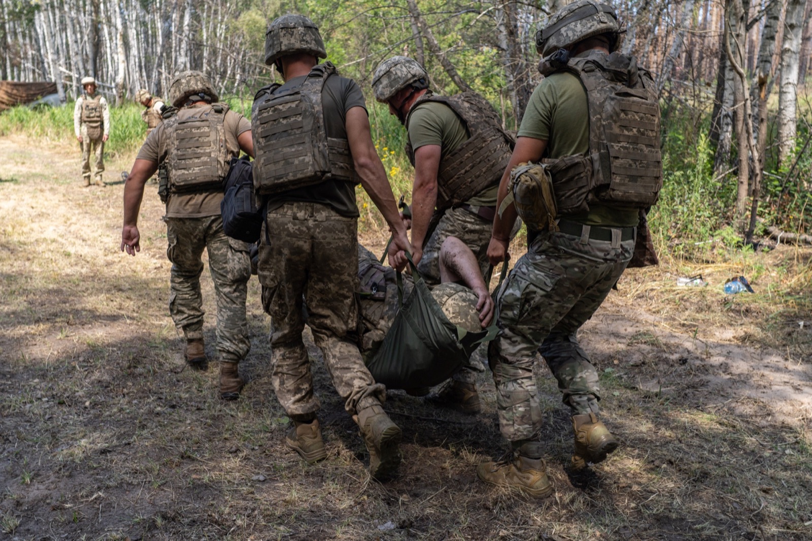 Personnel conducting a casualty evacuation exercise during field training